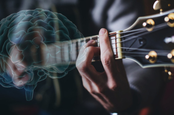 A person playing a guitar with a blue brain overlay. Music. 