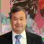 Dr. Geoff Ling in front of multicolored background, closeup, vertical. Co-leader, The BrainHealth Project.
