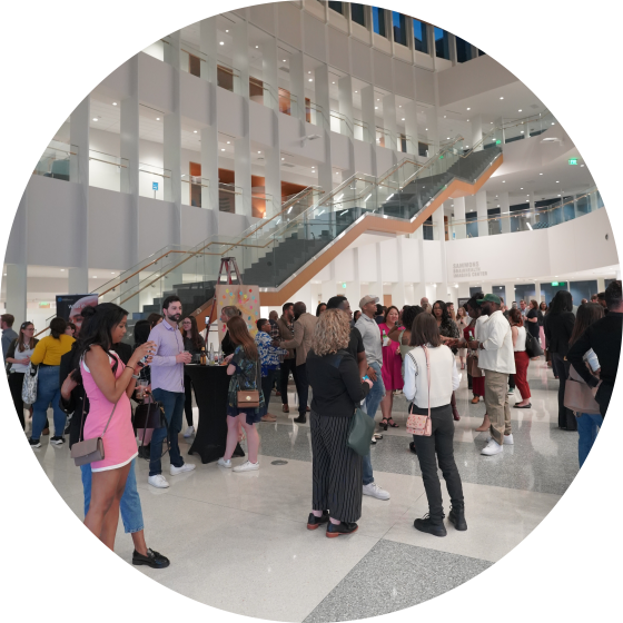 The crowd mingles and enjoys the Art-Infused Happy Hour at BrainHealth Week 2023.