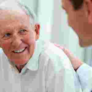 Elderly Caucasian Male Smiling with Doctor. Older white man.
