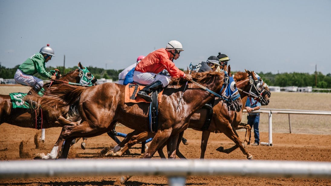 Men on horses racing