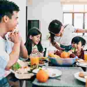 Asian ethnicity family having breakfast at home.
