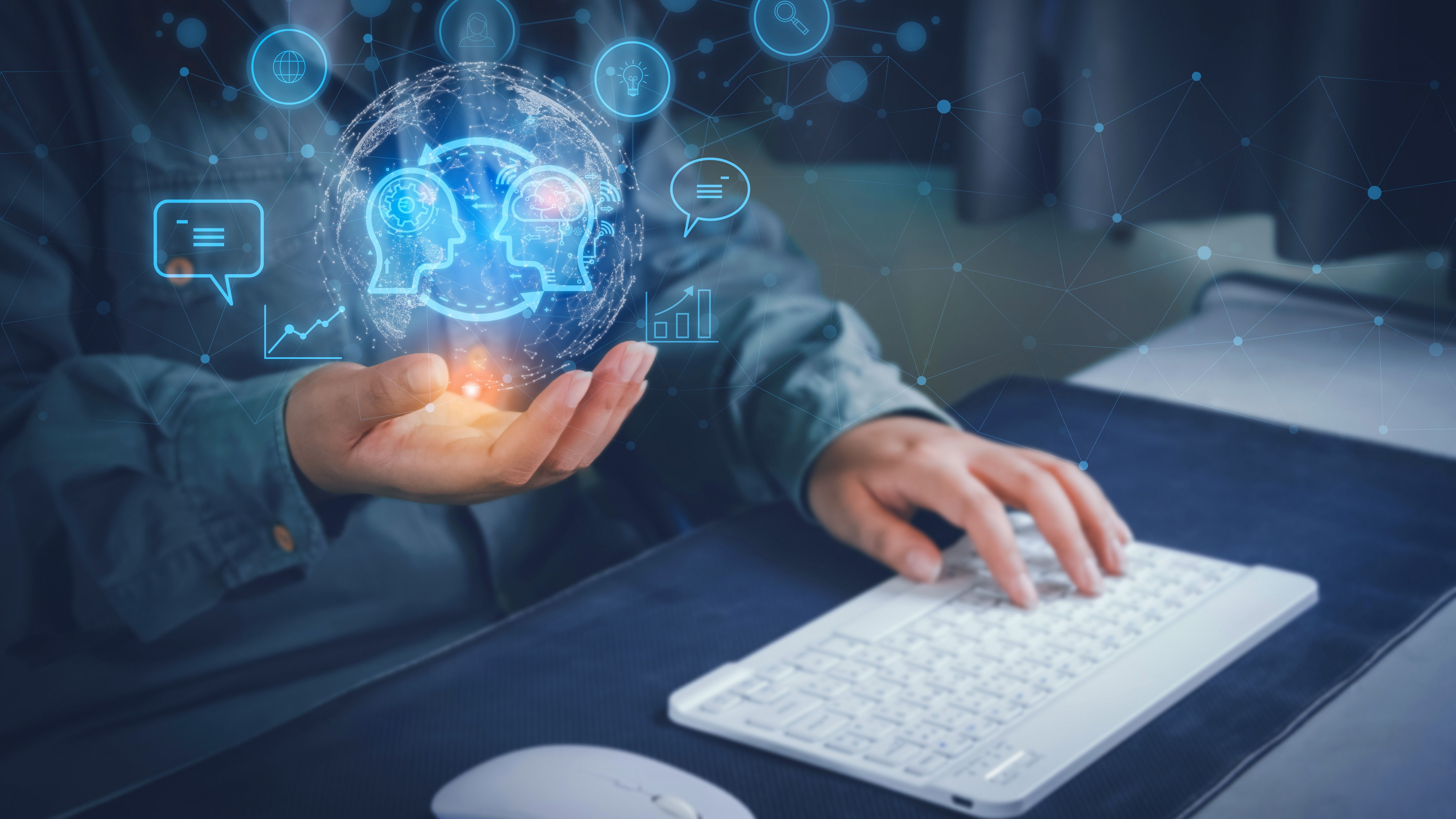 Person holding a glowing AI brain hologram while typing on a white keyboard, surrounded by blue digital icons.
