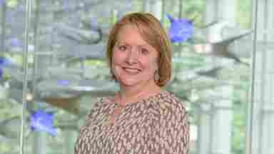 Audette Rackley is wearing a tan blouse with blue lights, landscape. Assistant Director of Strength-Based Programs- hero (?)