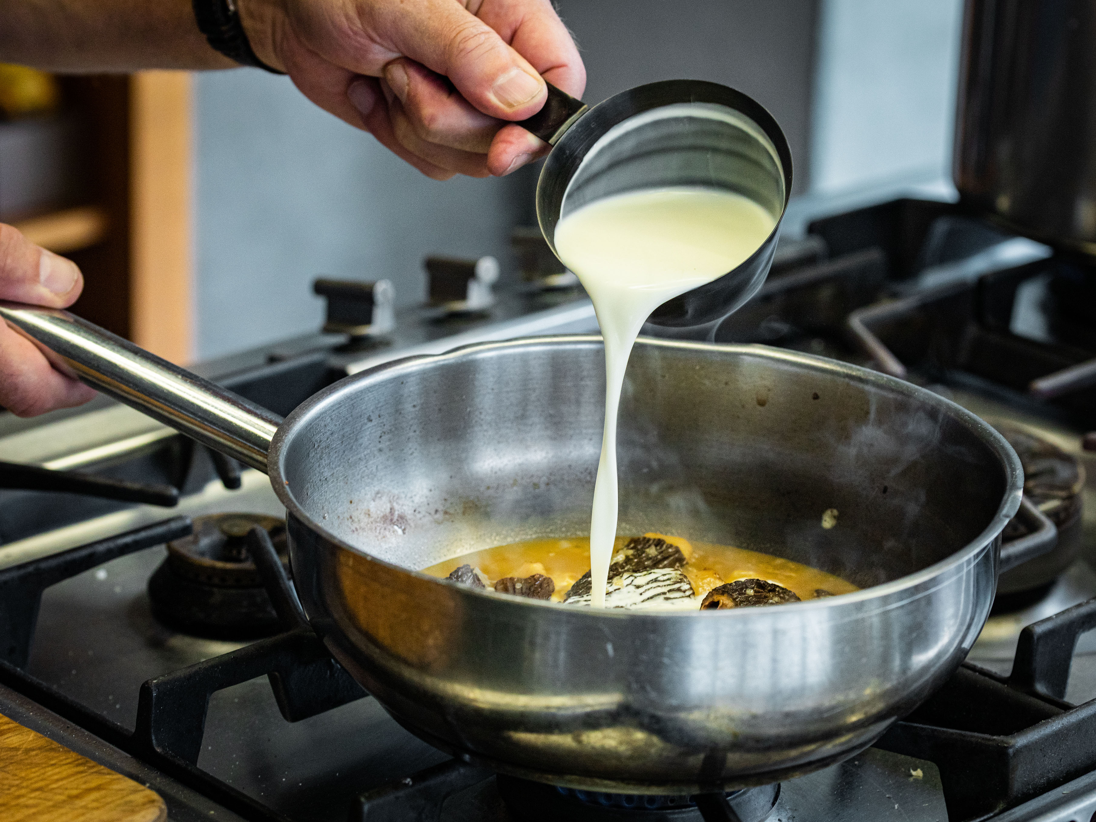 Schritt 3: Morcheln herausheben, den Rahm zufügen und bei grosser Hitze um die Hälfte einkochen lassen