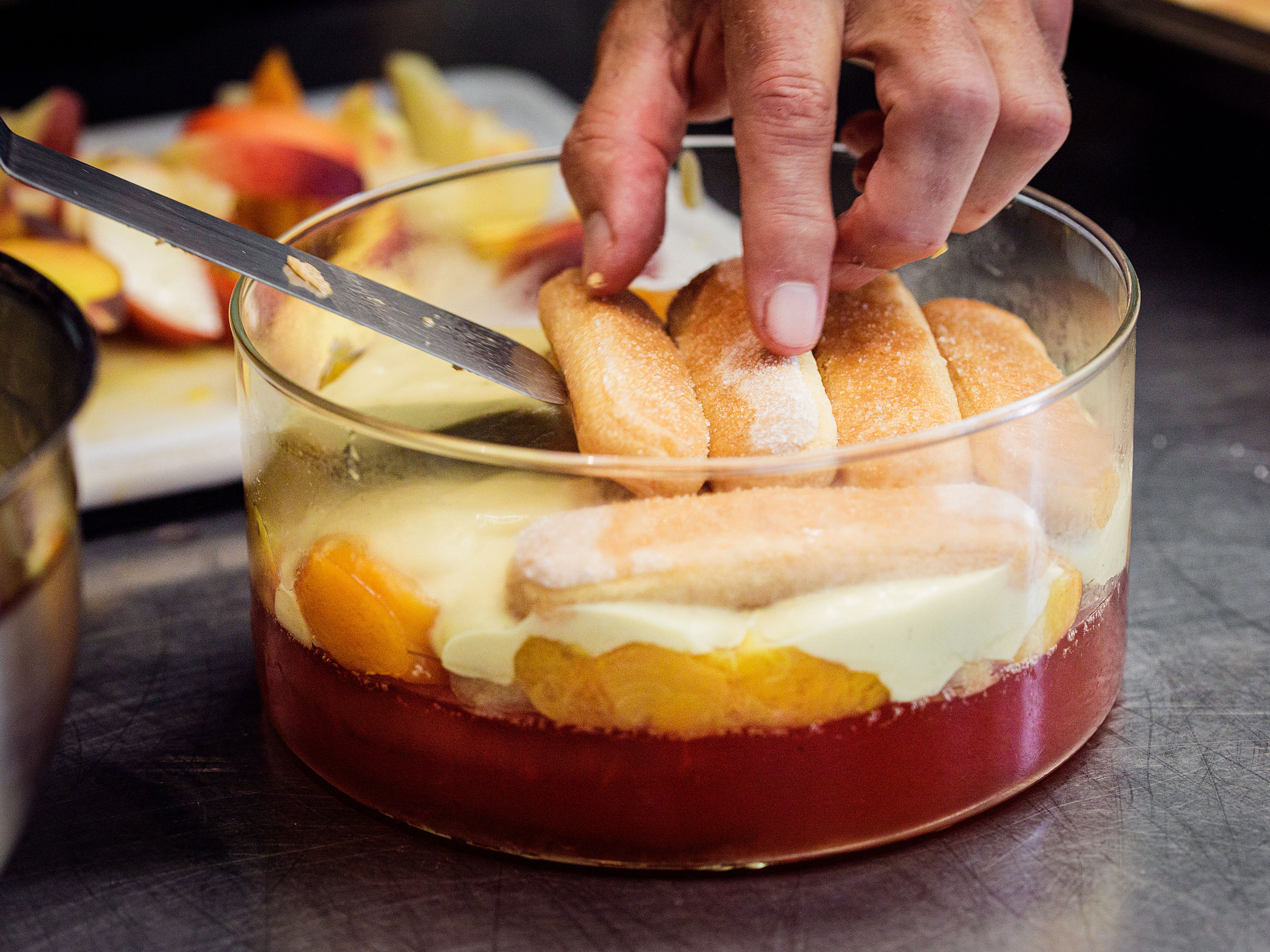 Schritt 4: Die Brandy-Creme Schicht mit einer weiteren Schicht Löffelbiscuits und einer weiteren Schicht Pfirsiche bedecken