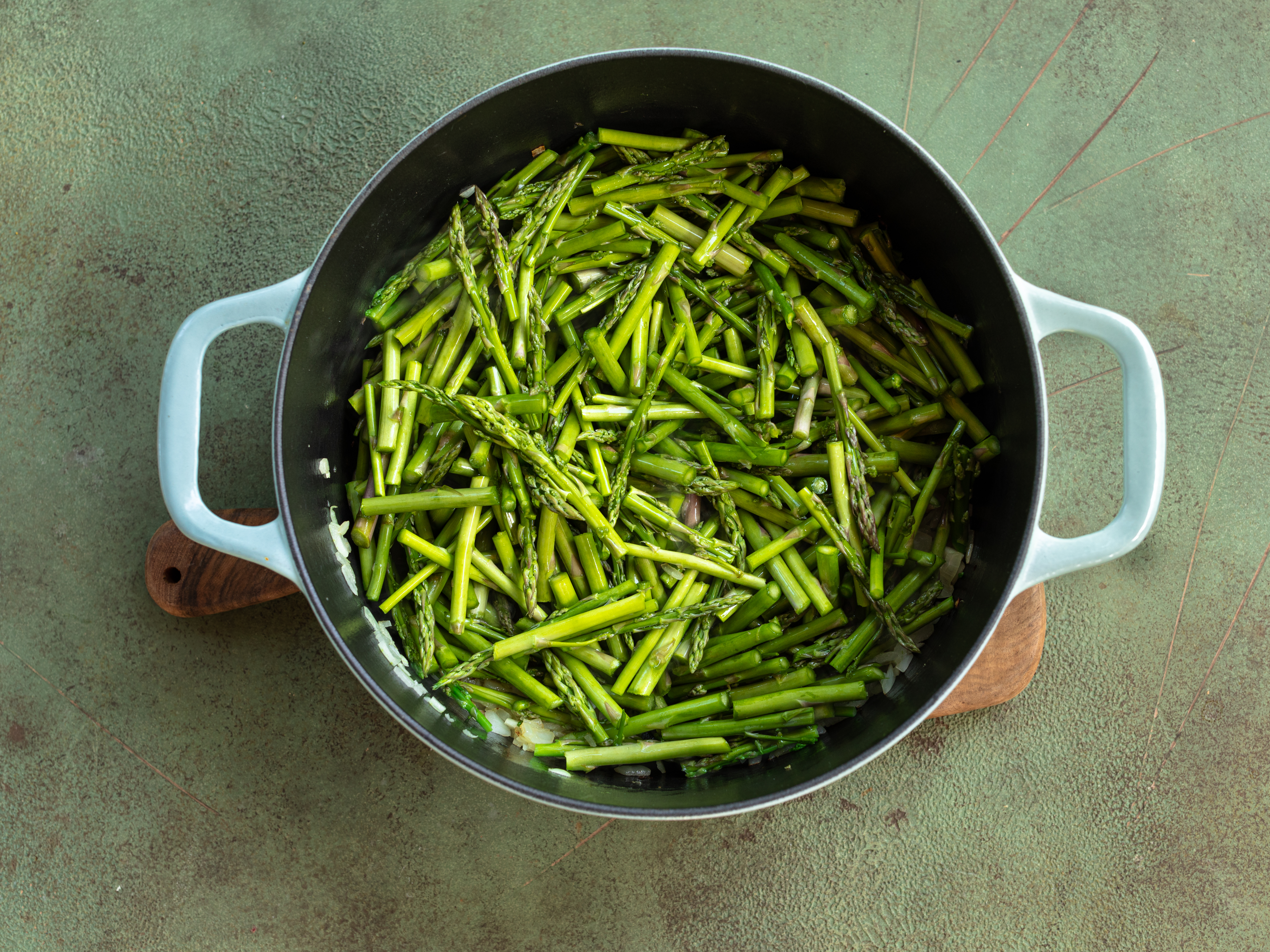 Schritt 1: Den geschnittenen Spargel in den Topf geben und etwa 5 Minuten lang anbraten, bis er leicht gebräunt ist