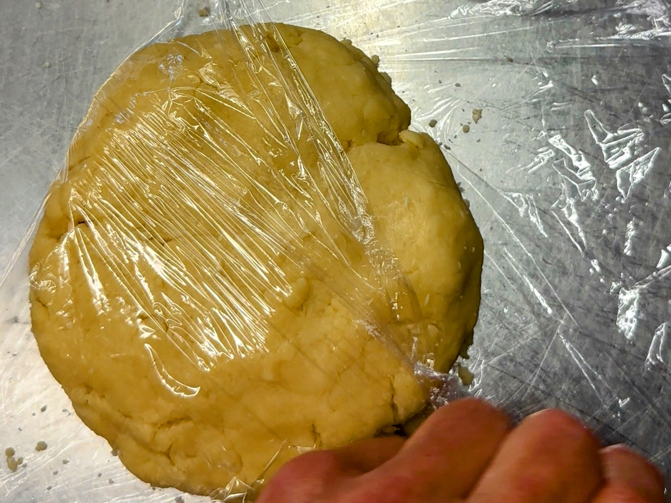 Schritt 1: Aus zwei Dritteln des Teiges eine grössere Scheibe und aus dem restlichen Drittel eine kleinere Scheibe formen. Jede Teigscheibe in Frischhaltefolie wickeln und mindestens eine Stunde lang in den Kühlschrank legen