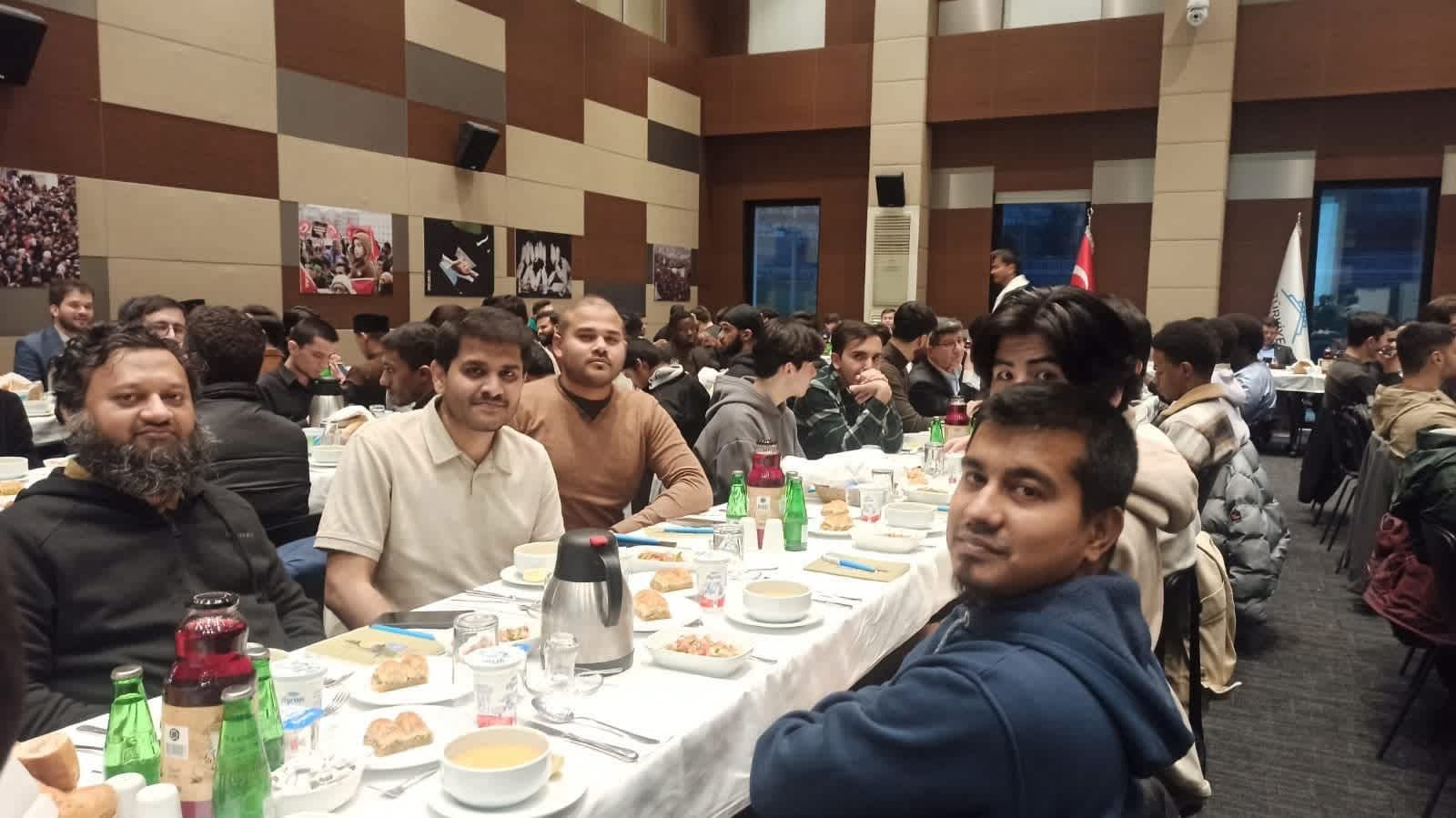Members of the RBDS delegation participating in an Iftar meal with foreign students, symbolizing cultural unity and shared community during the Ramadan season.
