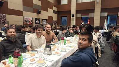 Members of the RBDS delegation participating in an Iftar meal with foreign students, symbolizing cultural unity and shared community during the Ramadan season.