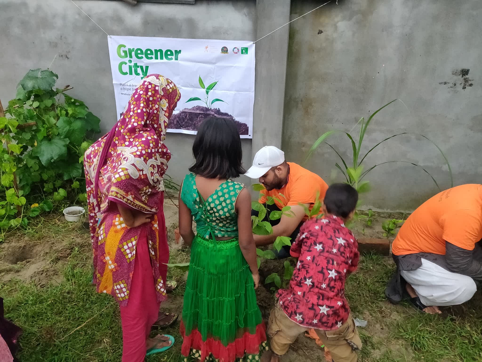 Runner Bangladesh member planting a tree during a tree-planting campaign