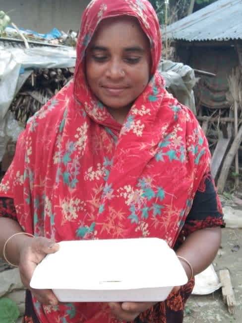 Woman receiving food as part of relief distribution