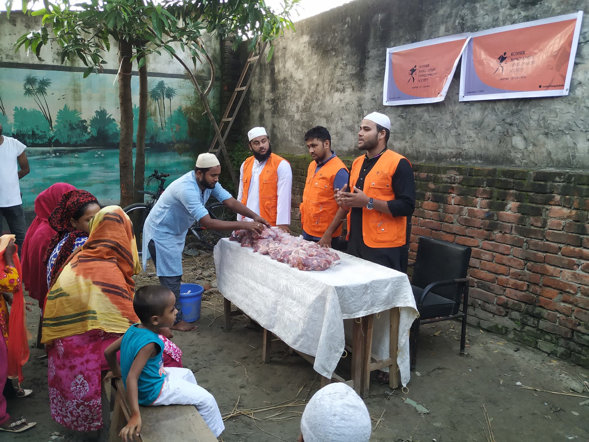Volunteers distributing meat on behalf of RBDS to families.