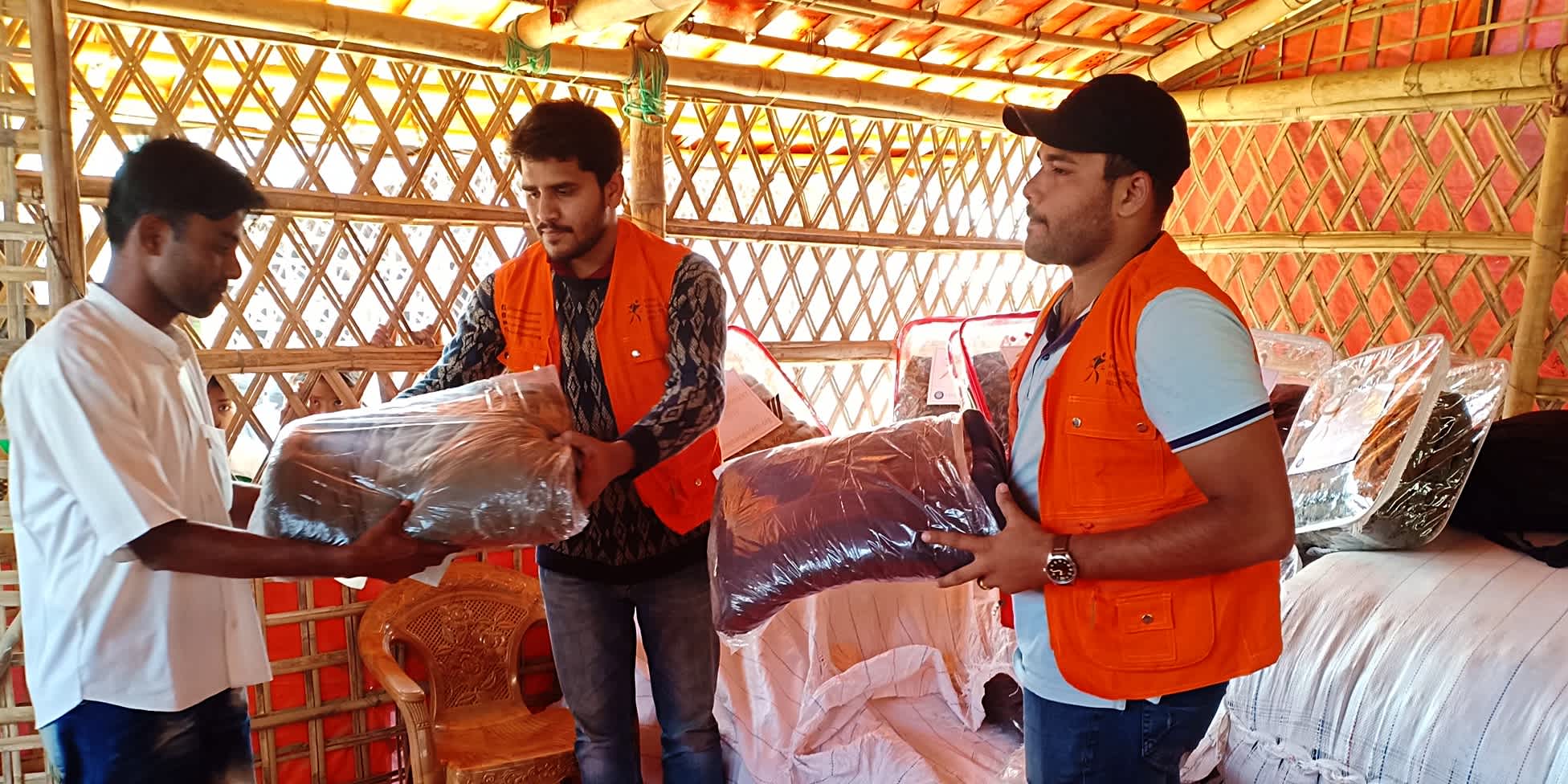 Runner Bangladesh officials distributing warm clothes to displaced Rohingya