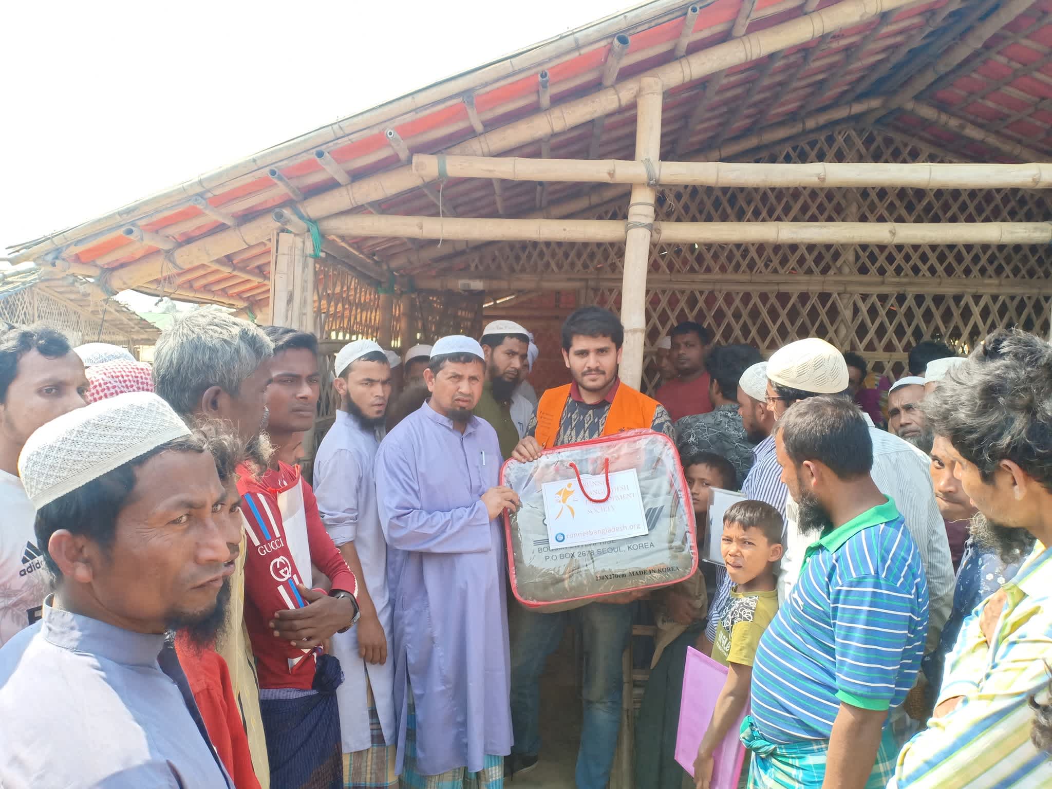 Rohingya people receiving blankets from Runner member