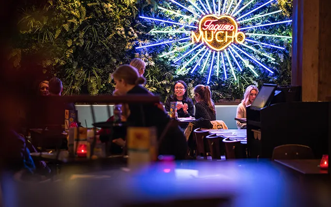 Neon light and plant wall in Las Iguanas Bath