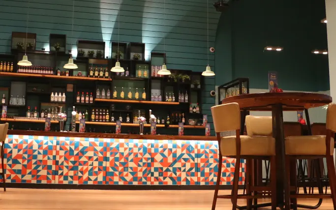Multicolour tiled bar front and bar tables at Las Iguanas Lakeside