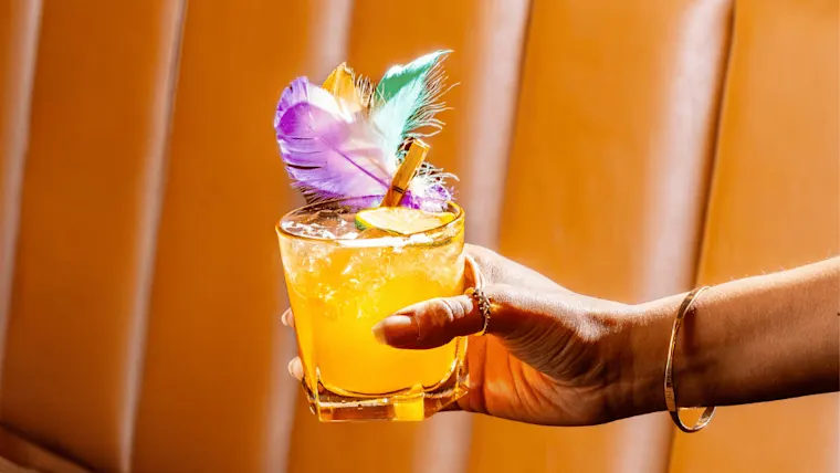 A woman holding a decorative cocktail