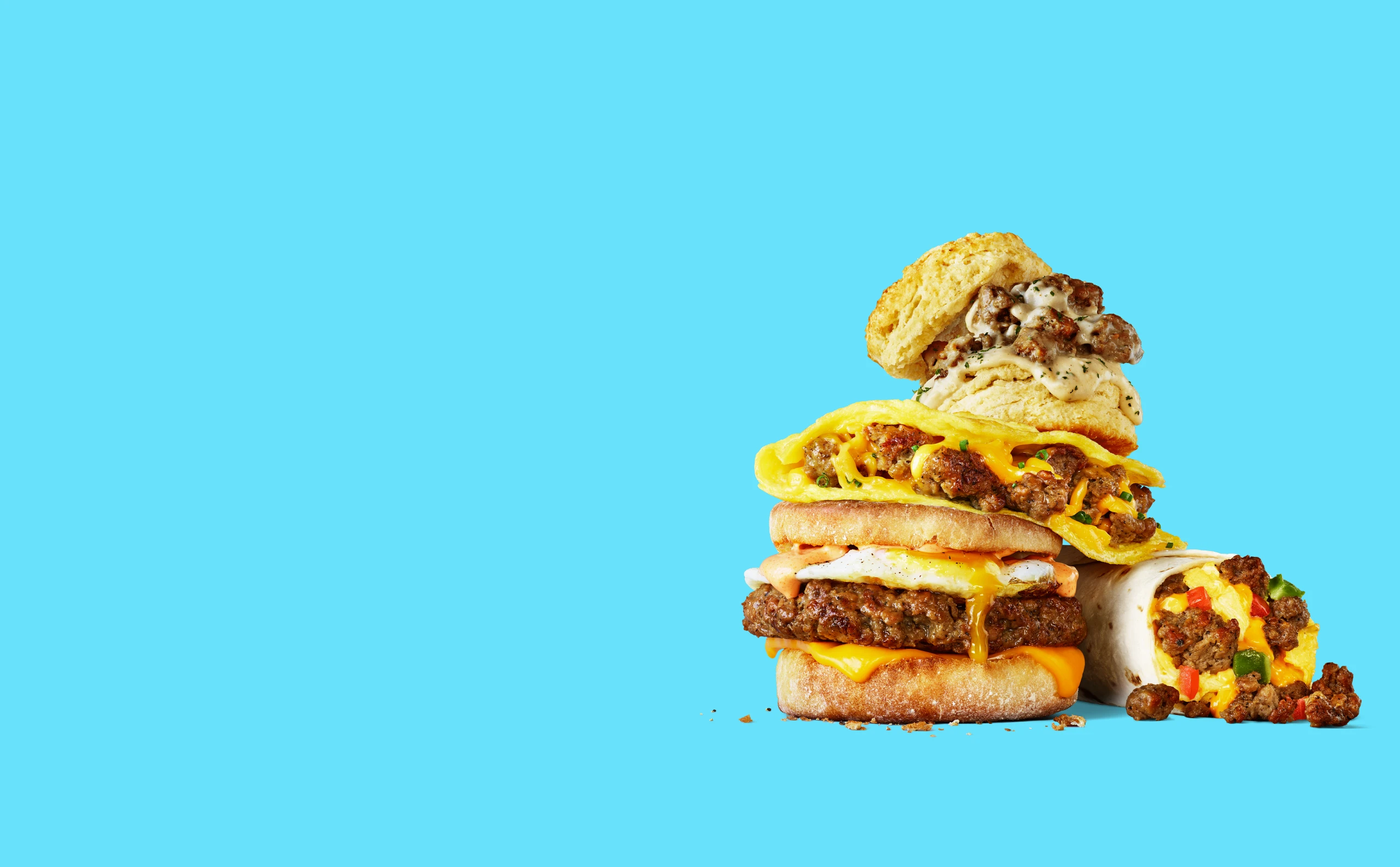 Impossible sausage food items stacked on top of one another on blue background
