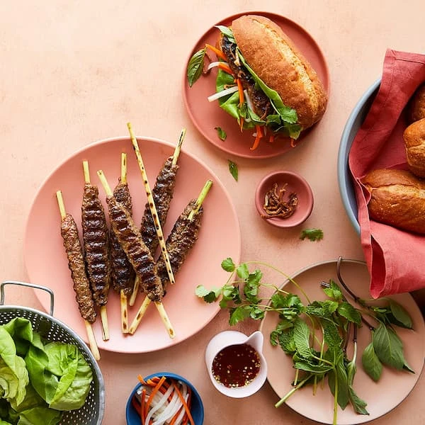 Impossible skewers on a plate, sandwich and fresh greens