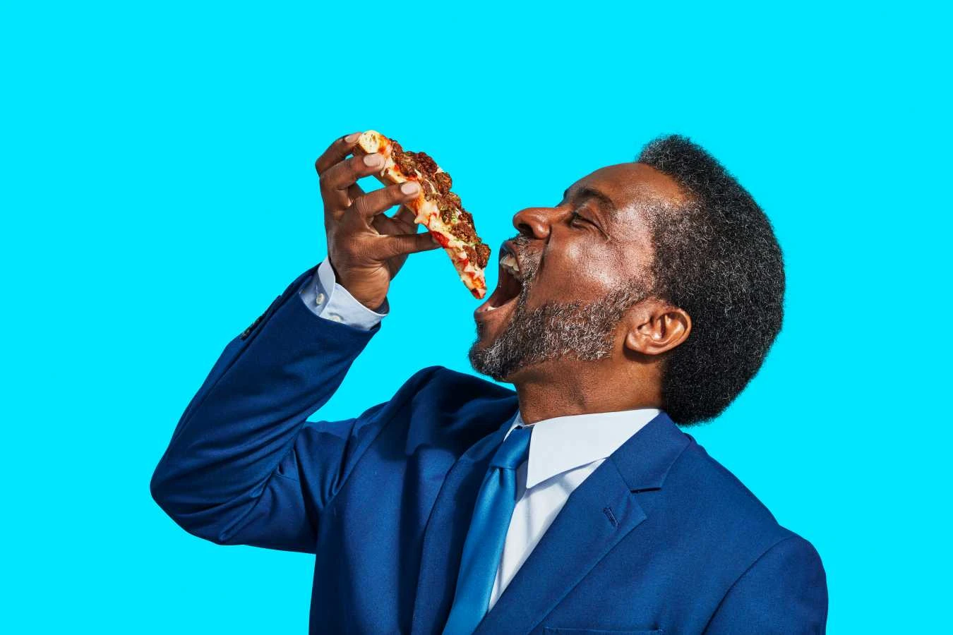Man eating Impossible™ pizza