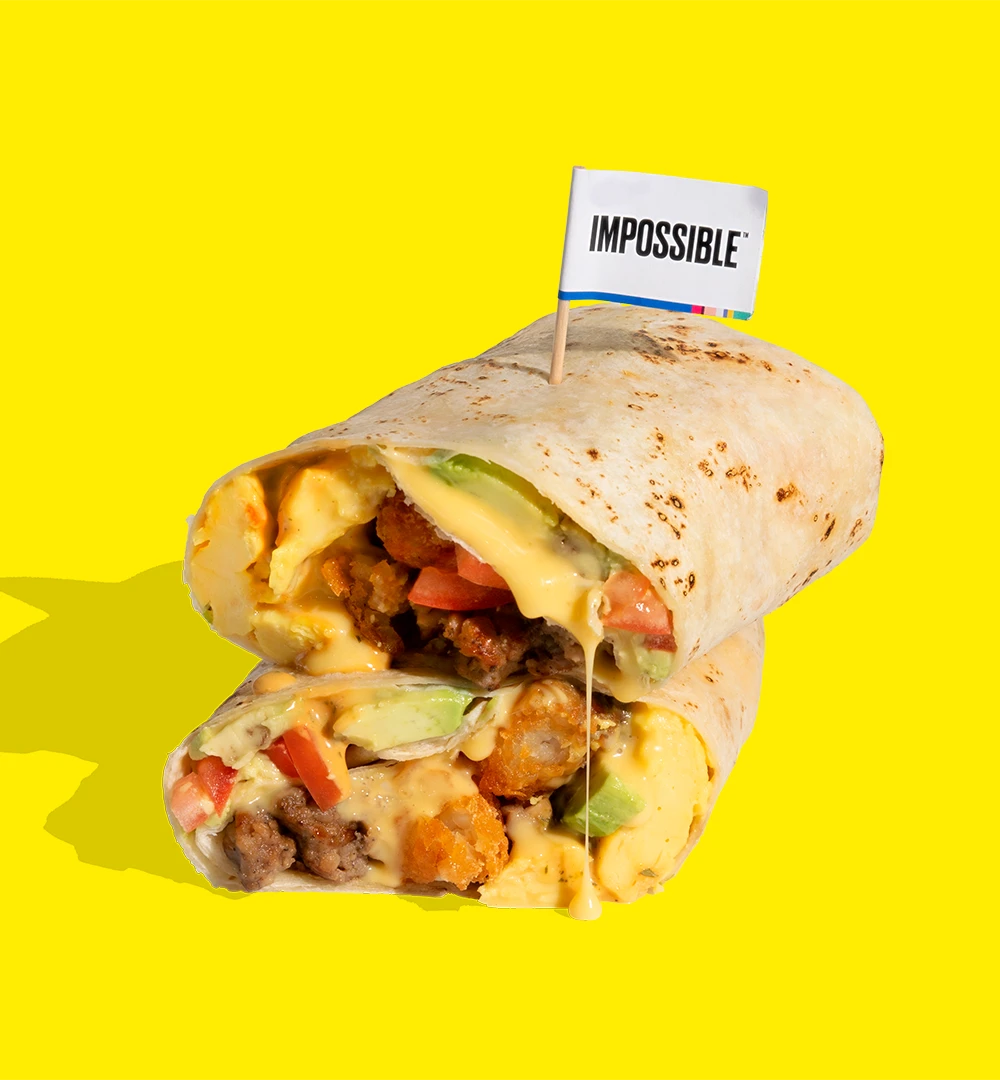 Impossible Breakfast Sausage Burrito - crumbled Impossible sausage & plant-based egg, crispy tater tots, tomatoes, avocado, plant-based cheese whiz & chipotle-lime crema wrapped in a warm tortilla