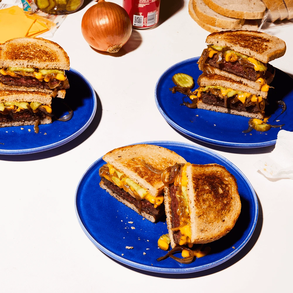 Recipe for Impossible Patty Melt made with Impossible Burger on blue plates