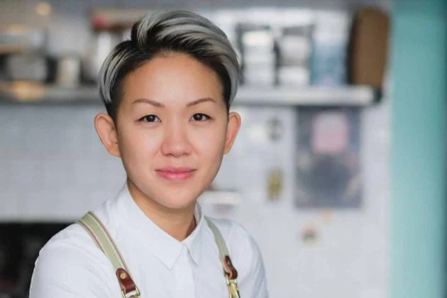 Headshot of Chef May Chow wearing an apron  in a restaurant 