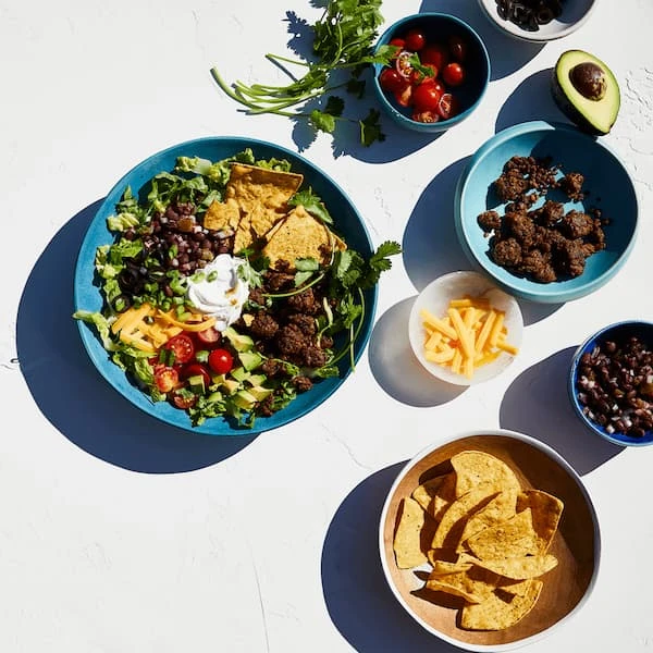 Impossible Burger in a salad with nachos, cheese and herbs