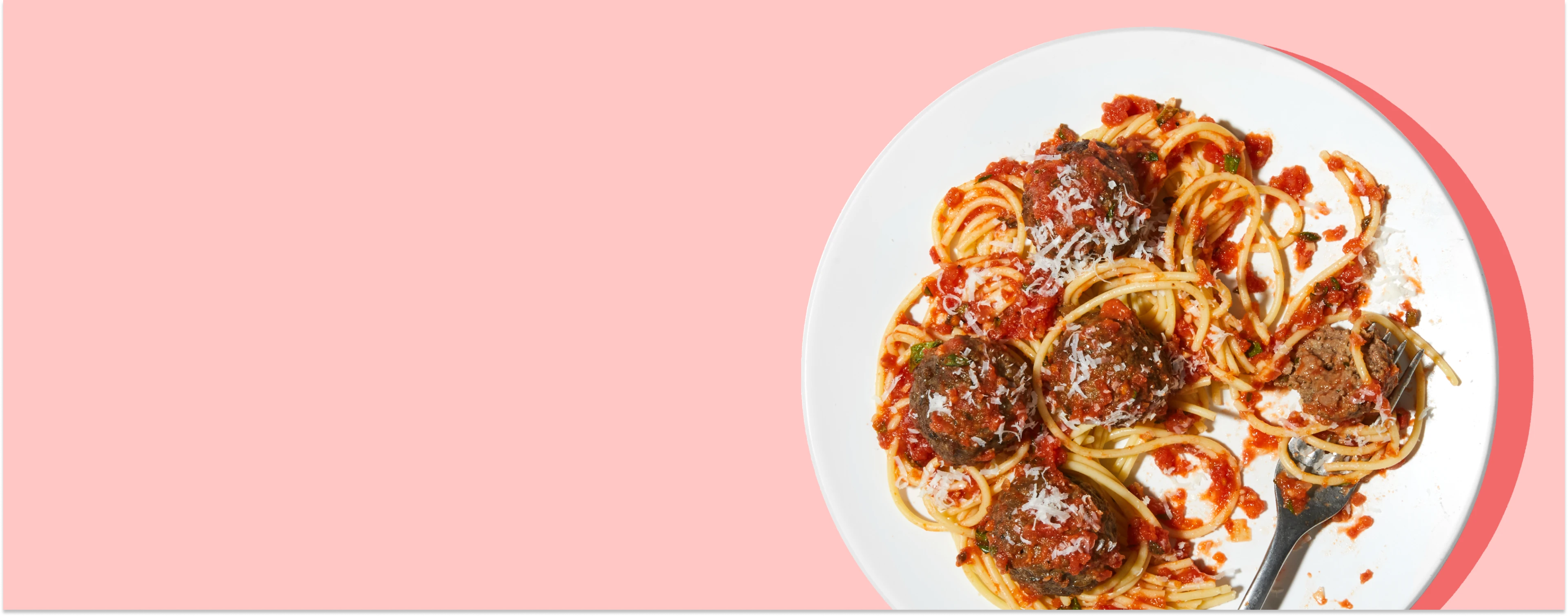 Impossible Meatballs plated with spaghetti on a light bakground