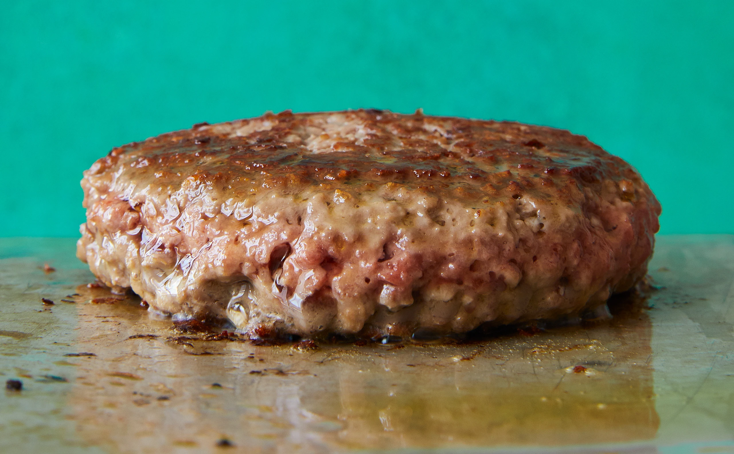 Impossible burger patty cooked on a griddle