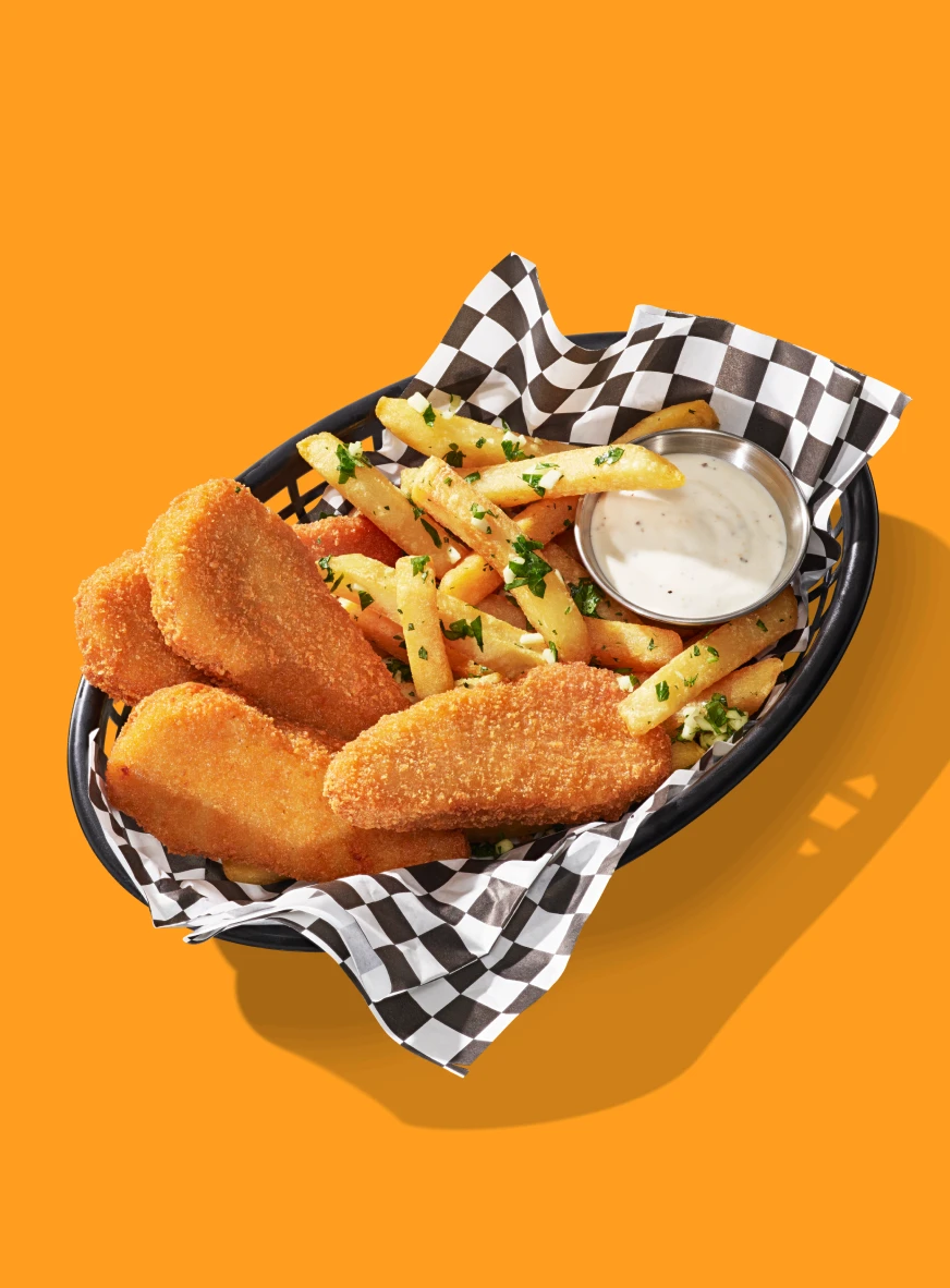 Impossible Chicken Tenders for foodservice showcased within a basket of fries