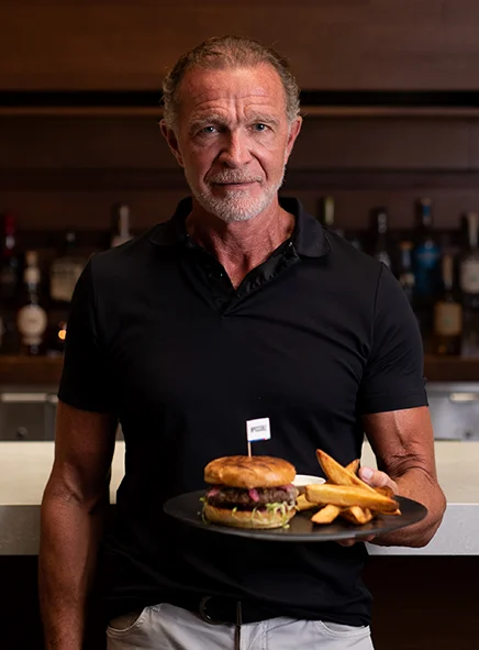 Chef Mark McEwan from Bymark holding an Impossible Burger dish