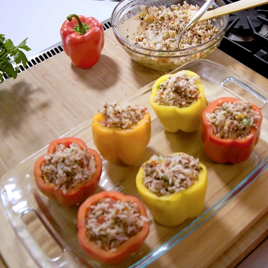 Multi colored Impossible Stuffed Bell Peppers made with Impossible Burger by Chef Mimi in glass baking dish