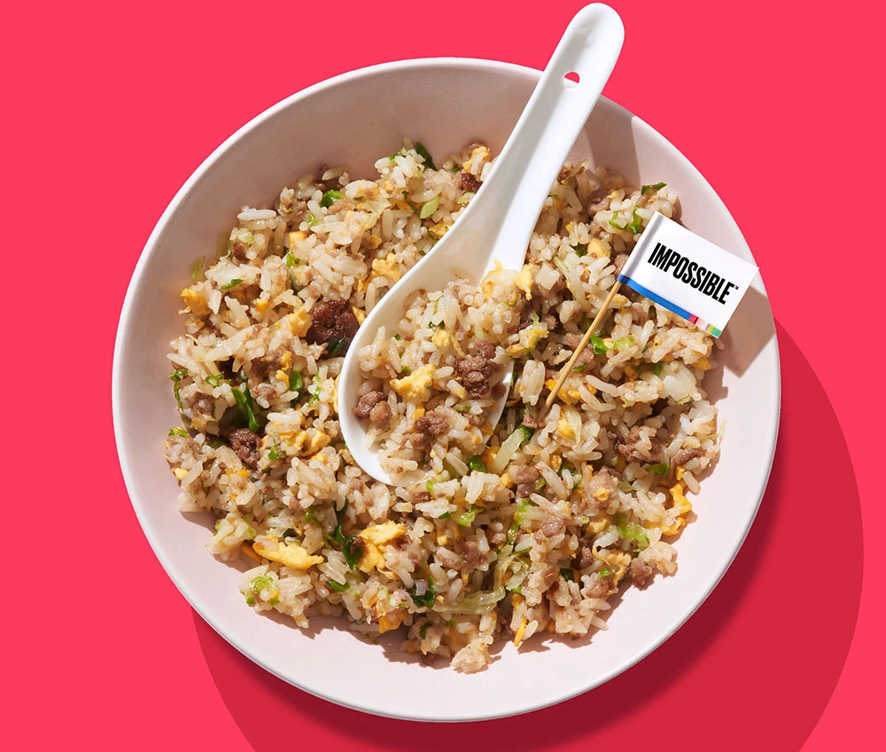 A bowl of Impossible™ Lettuce Fried Rice Recipe made with Impossible™ Burger.