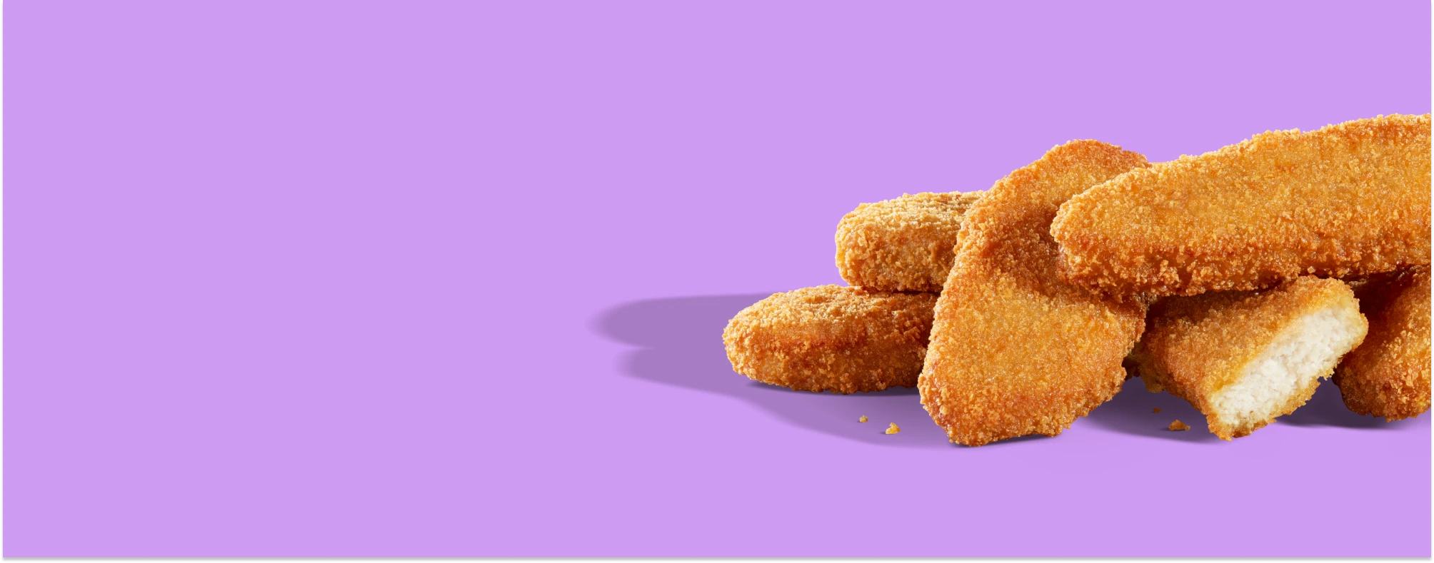 Impossible chicken tenders in a stack on a purple background