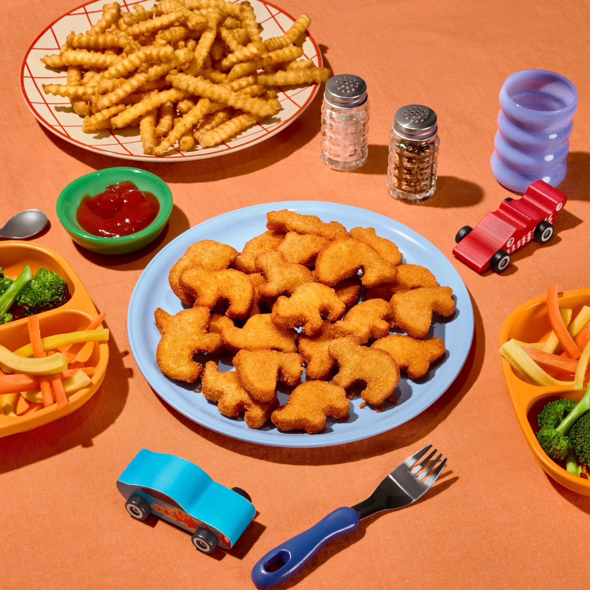 Impossible Wild Nuggies plated on a table with kids. toys