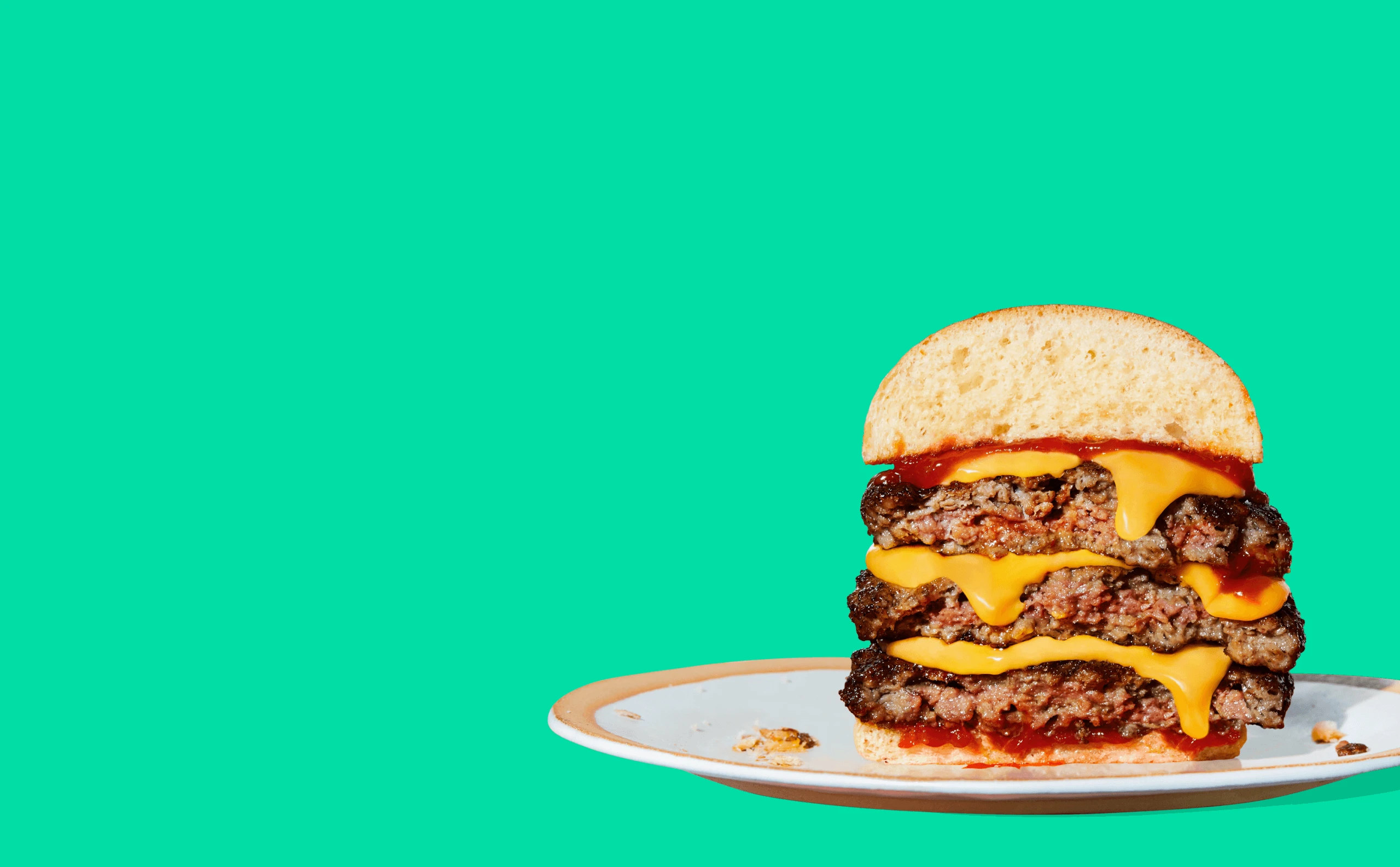 Image of juicy Impossible Beef cheese burger cut in half
