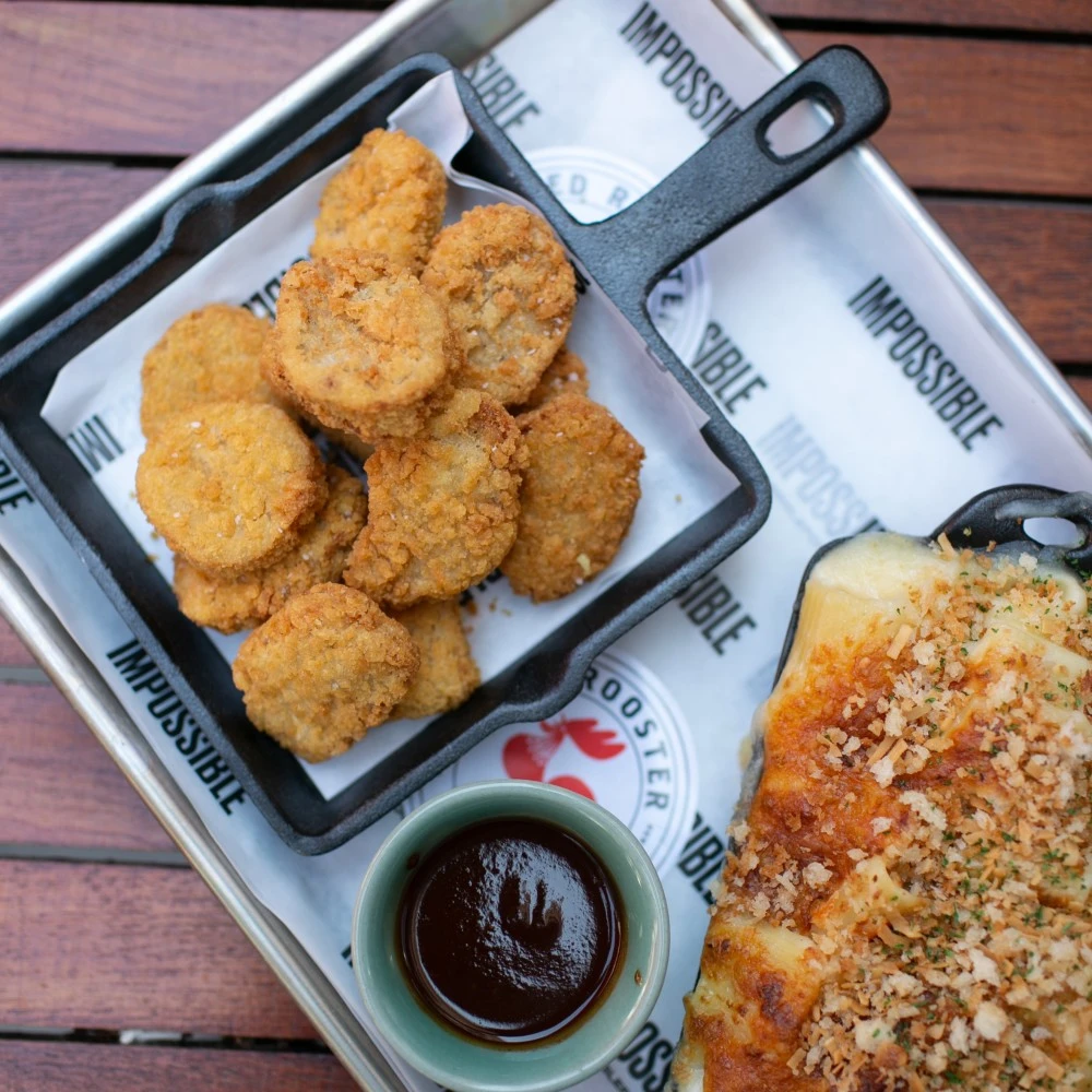 Impossible™ Chicken Nuggets served in a mini-skillet, with Jackfruit BBQ Sauce & Cauliflower Mac & Cheese 