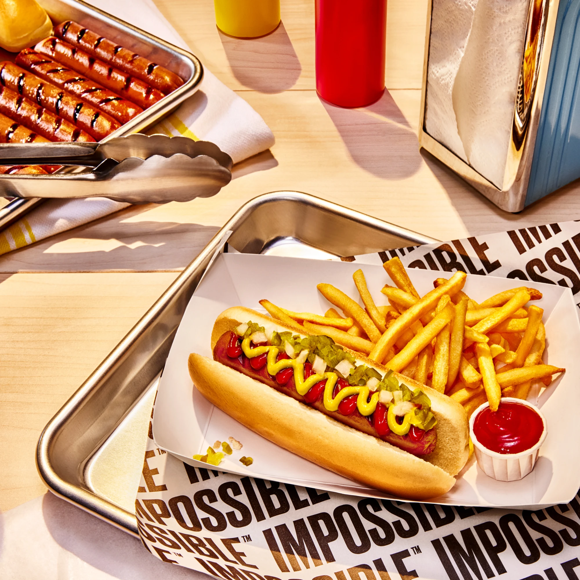 Impossible Beef Hot Dog served on a tray with fries