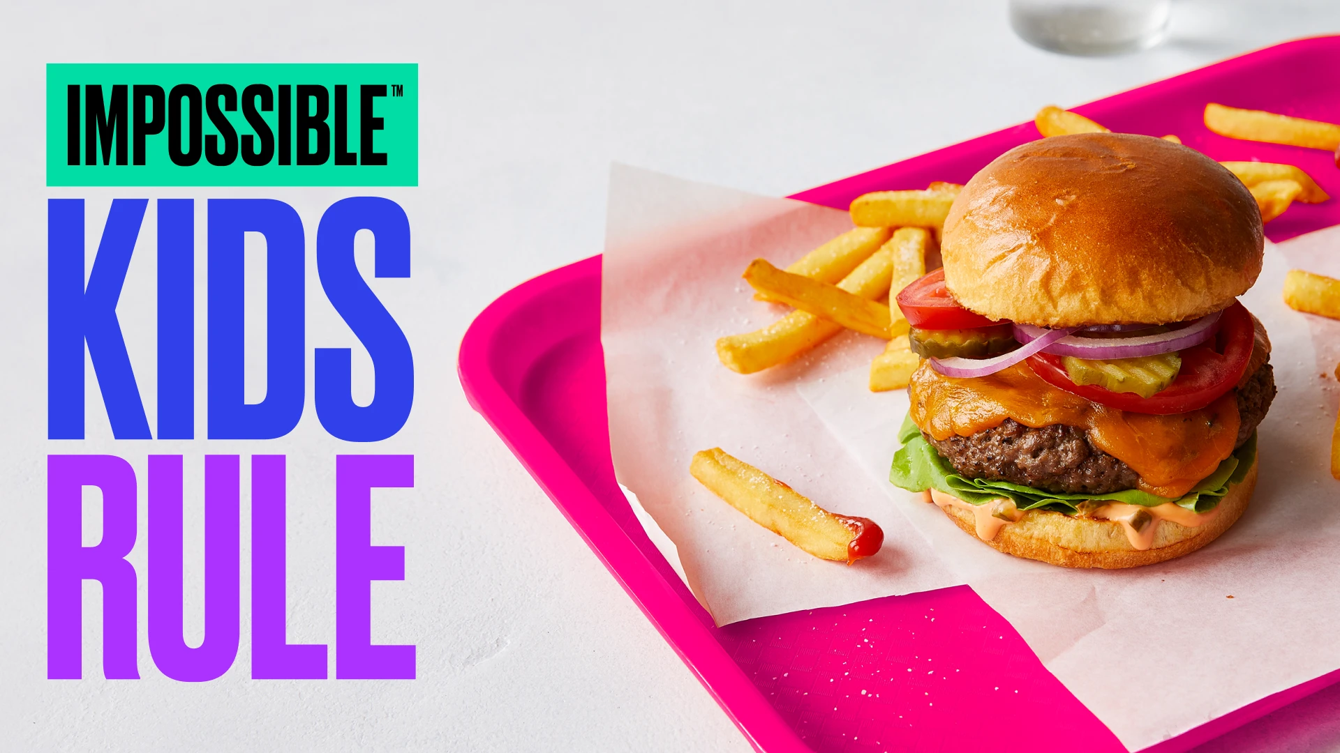 Impossible Burger on pink lunch tray with "Kids Rule" title.