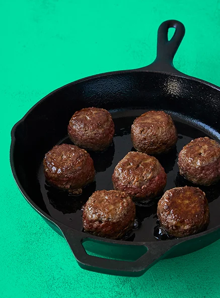 Impossible Burger meatballs in a cast iron skillet