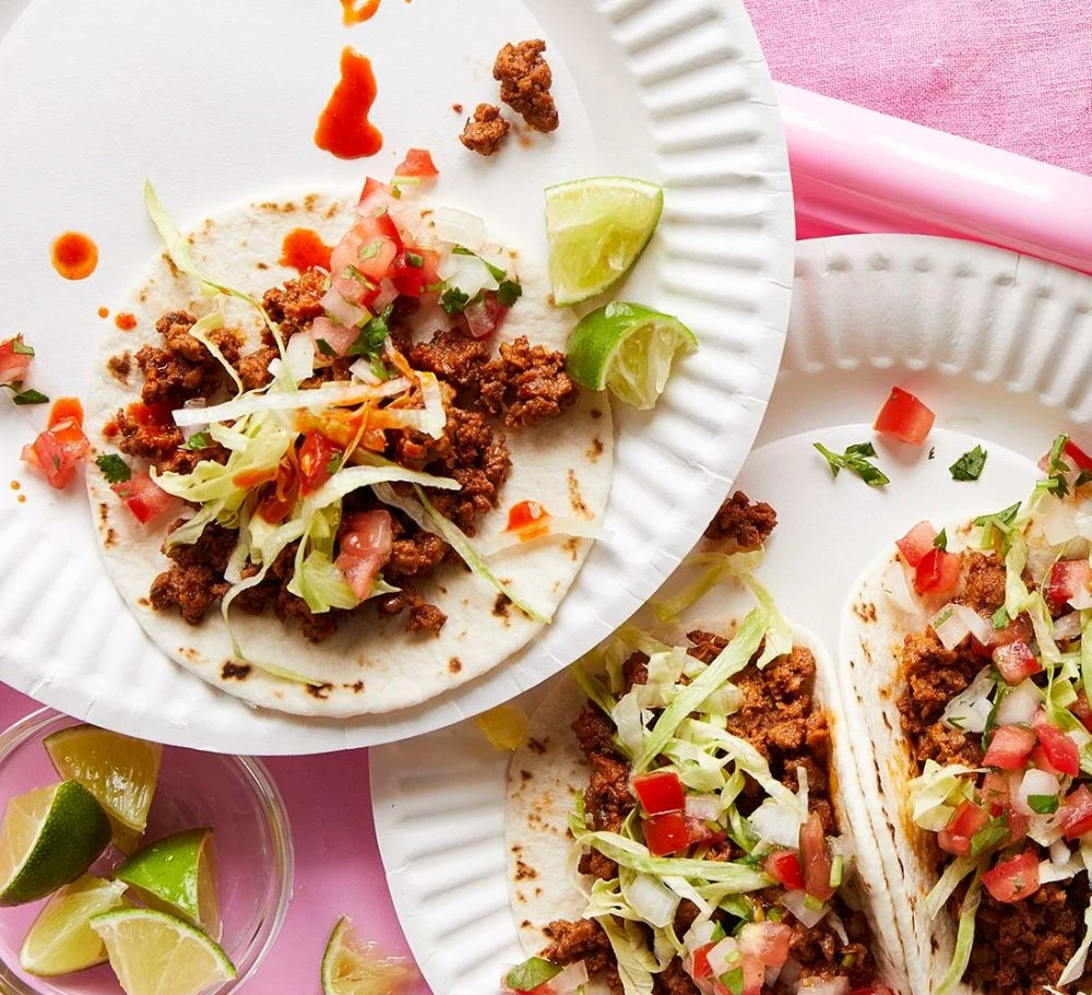 Impossible Street Tacos Recipe on paper plates by Impossible Burger.
