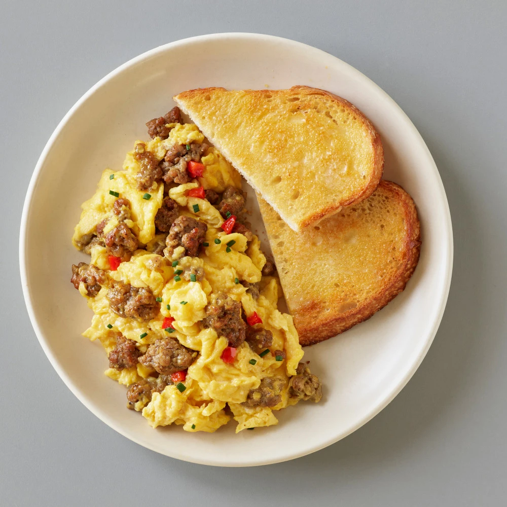 Impossible™ Sausage Scramble made with Impossible™ Savory Sausage Made From Plants and red bell pepper cooked with eggs