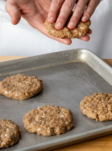 Impossible Sausage made from plants formed patties on a baking sheet