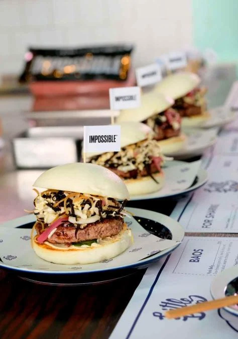 May Chow’s recipe for Impossible™ Bao plated on a table with other food dishes 