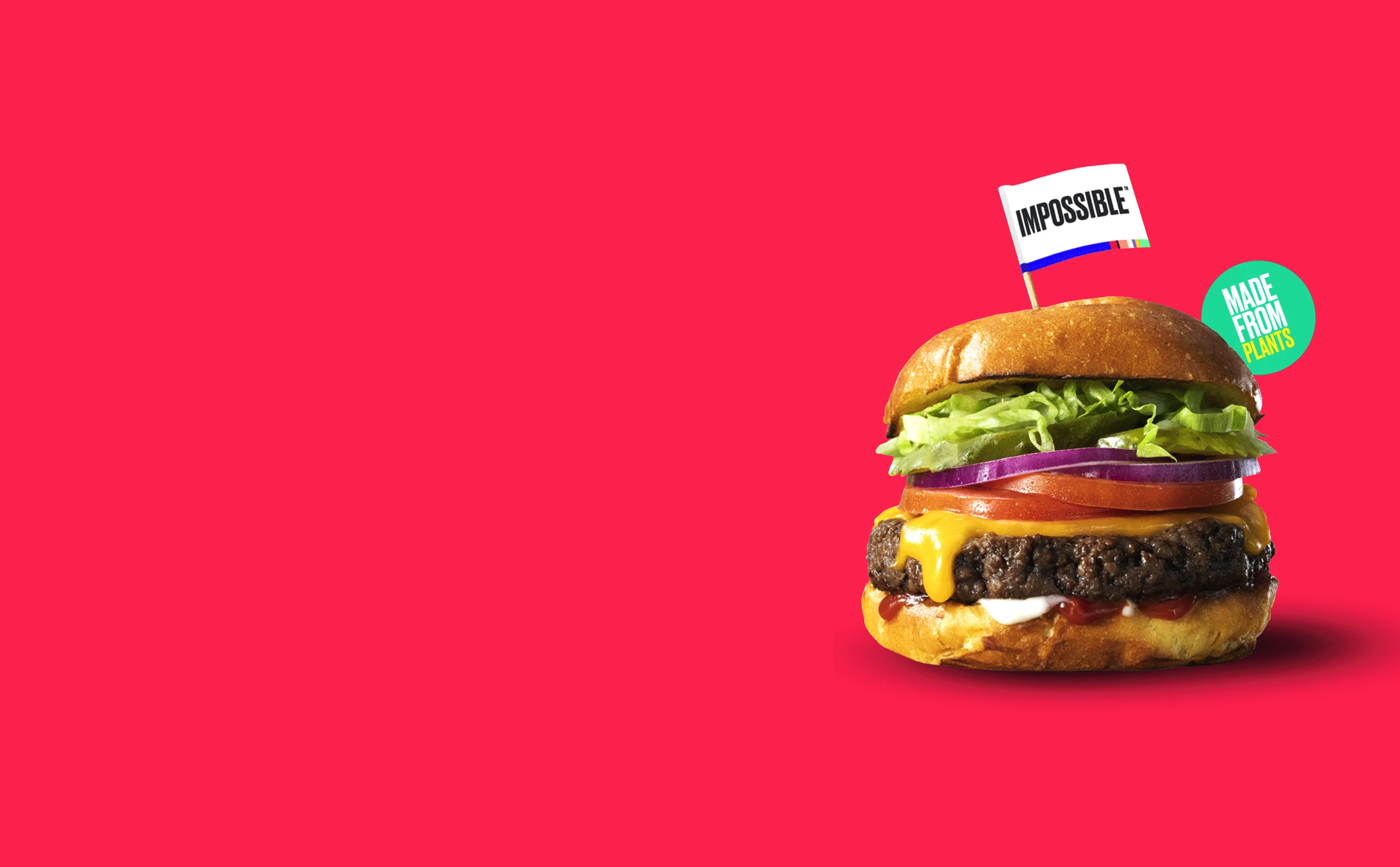 A juicy Impossible Burger topped with an Impossible branded flag