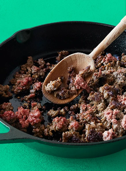 Impossible Burger crumbles in a cast iron pan