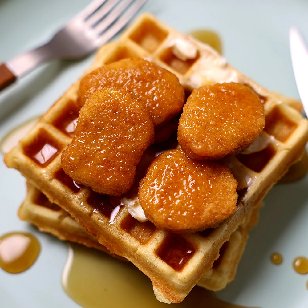 Chicken and Waffles made with Impossible Chicken Nuggets Made From Plants, and topped with spiced maple syrup. 