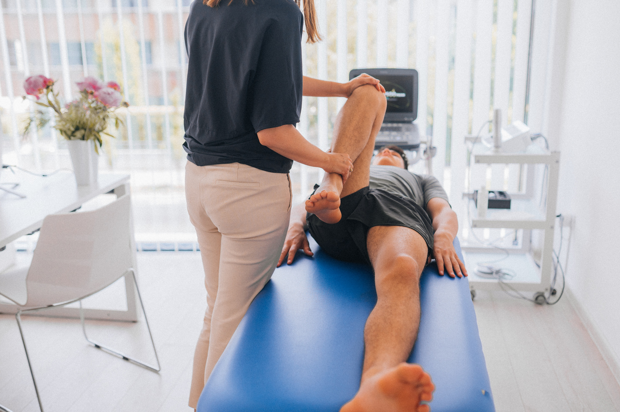 man-in-gurney-being-stretched-by-doctor